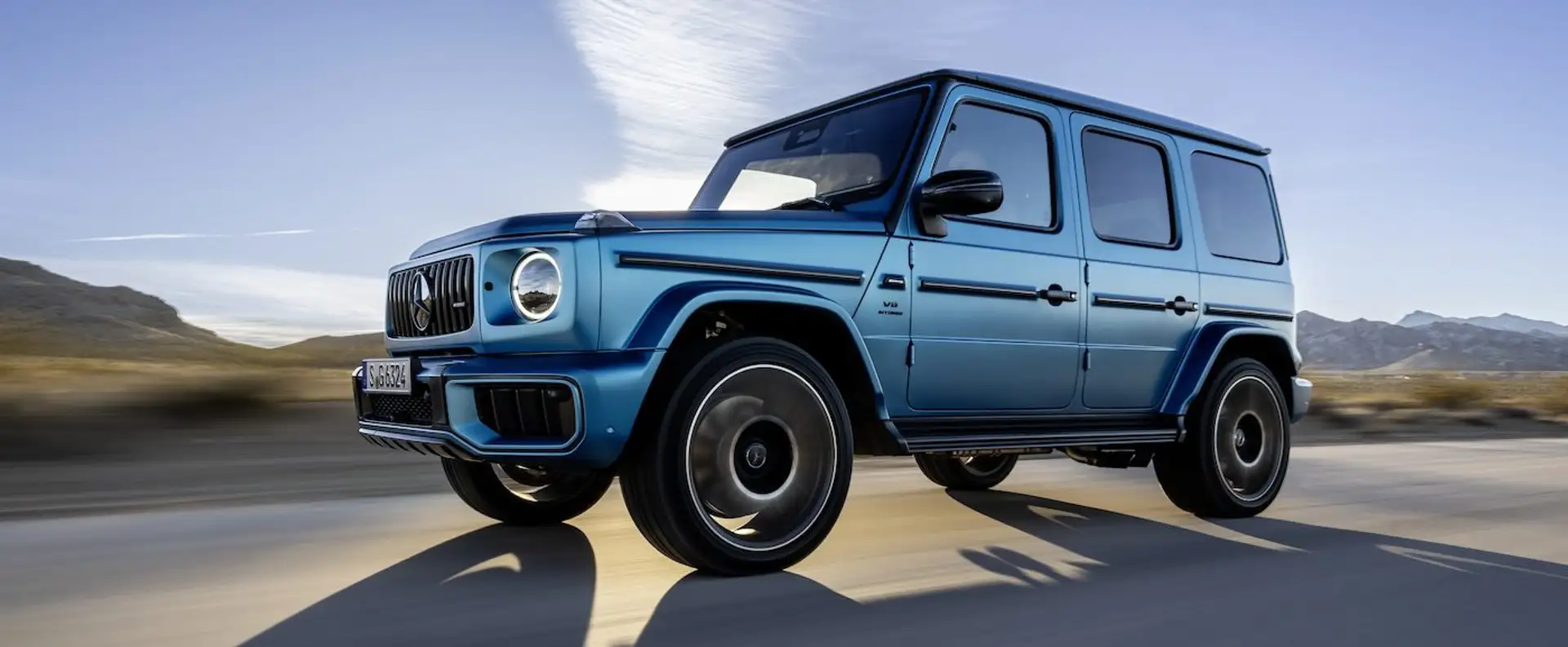 Mercedes-Benz G-Class in blue driving from the side