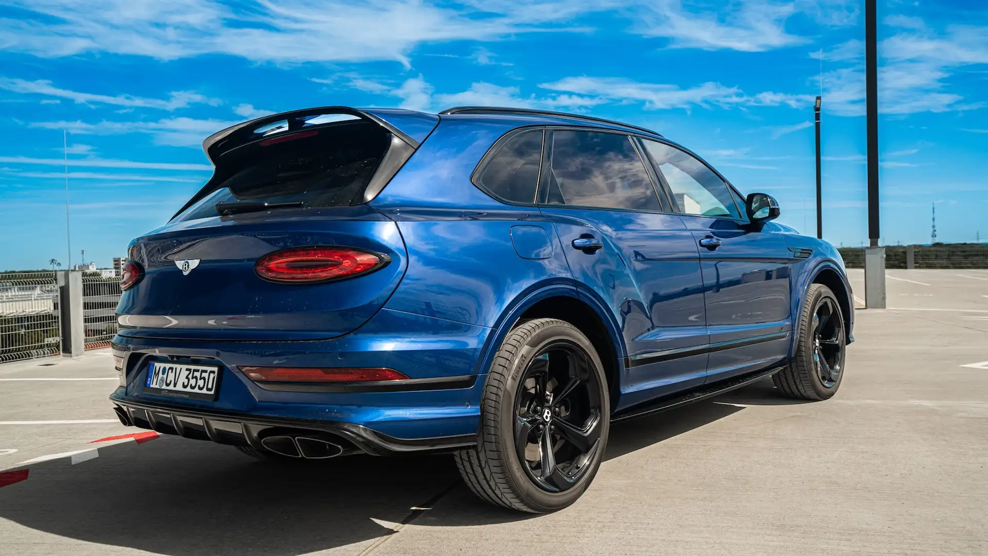 Bentley Bentayga V8S in blue on parking garage rear view