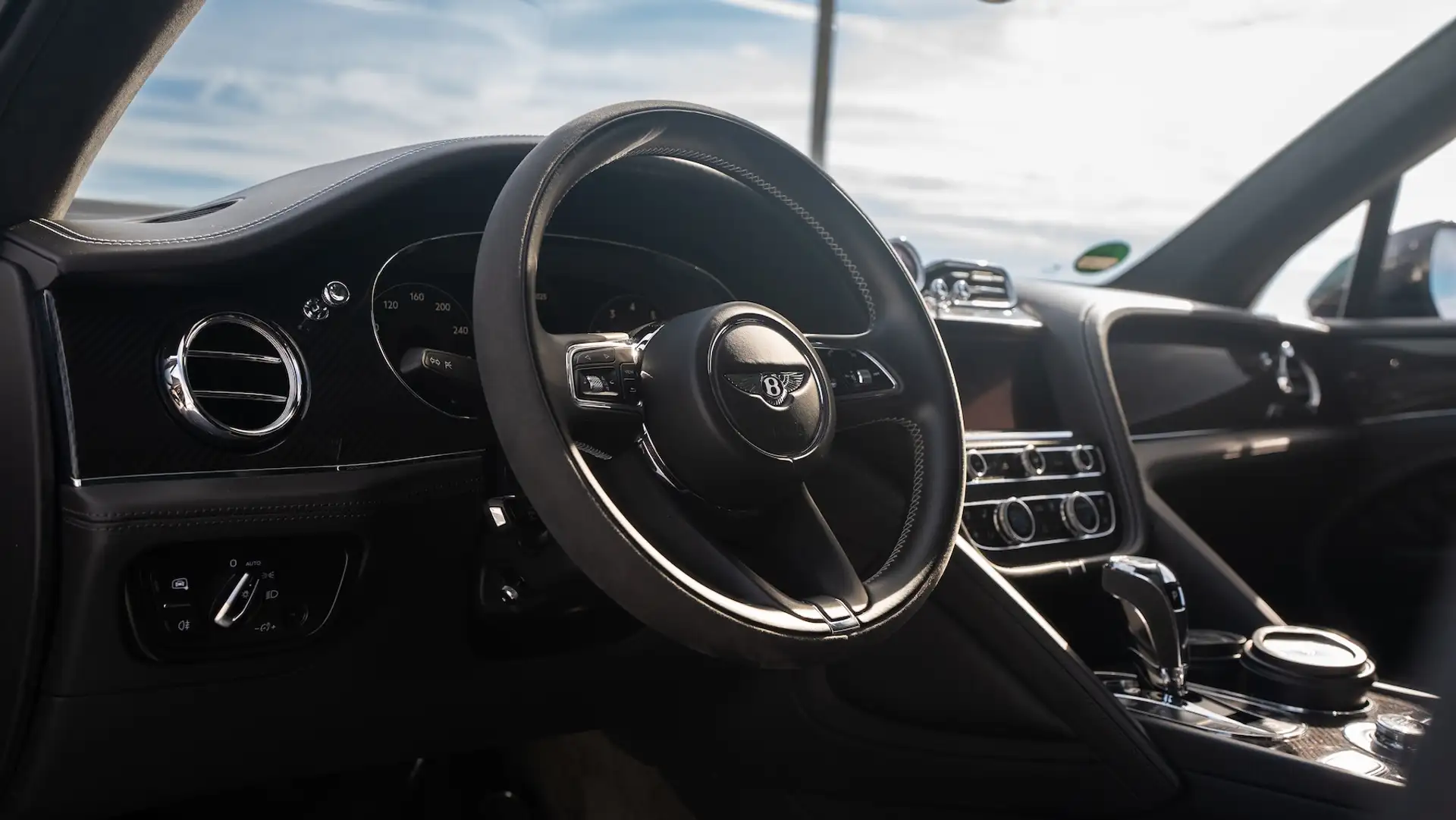 Bentley Bentayga steering wheel with logo and dashboard in black