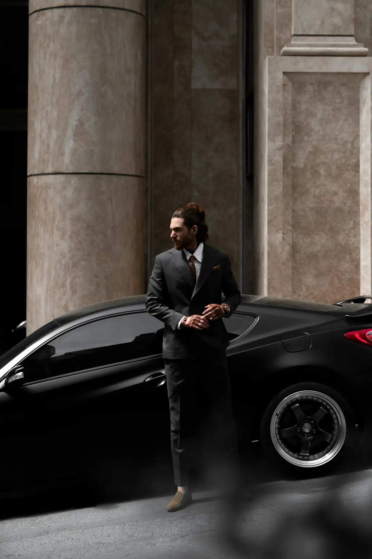 Man in front of luxury sports car